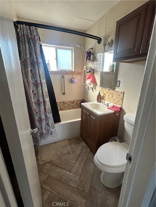 full bathroom with toilet, shower / tub combo, and vanity