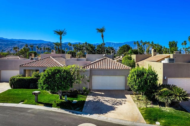 view of front of home with a mountain view and a garage