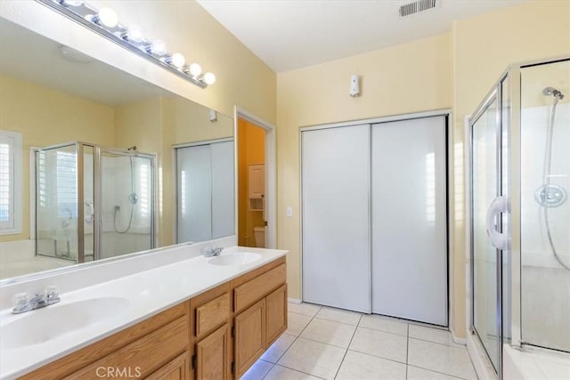 bathroom featuring vanity, tile patterned flooring, and an enclosed shower