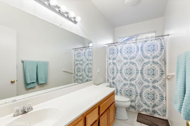 bathroom featuring toilet, a shower with curtain, tile patterned floors, and vanity