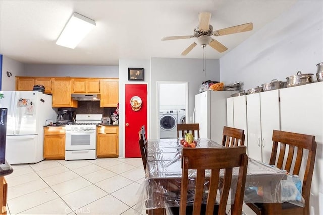 kitchen featuring white appliances, washing machine and dryer, decorative backsplash, ceiling fan, and light tile patterned floors