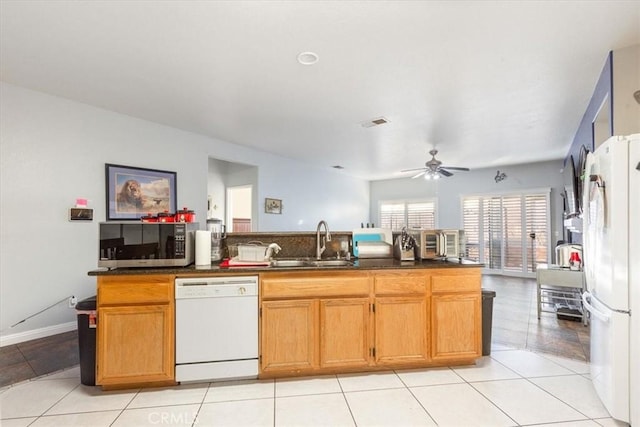 kitchen with ceiling fan, sink, white appliances, and light tile patterned flooring