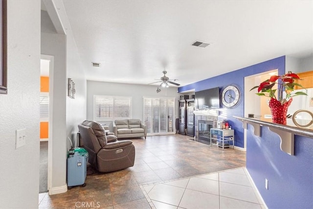 tiled living room featuring ceiling fan