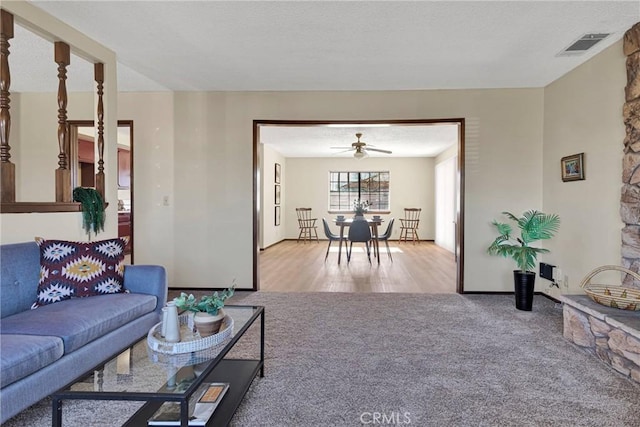 living room with ceiling fan and carpet flooring