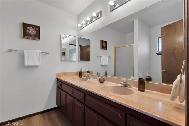 bathroom featuring a shower with shower door, vanity, and hardwood / wood-style floors