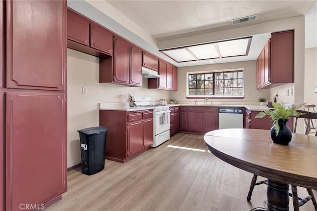 kitchen featuring stainless steel dishwasher, white range with gas cooktop, sink, and light wood-type flooring