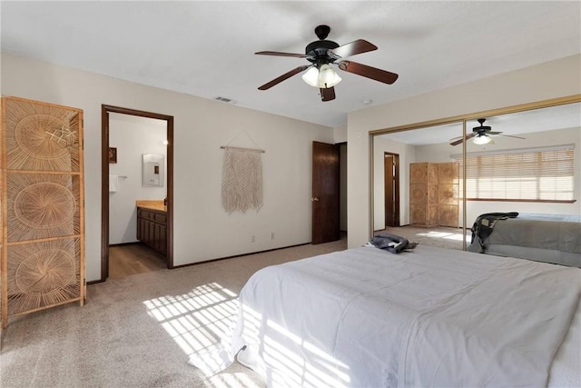 carpeted bedroom featuring ceiling fan, a closet, and connected bathroom