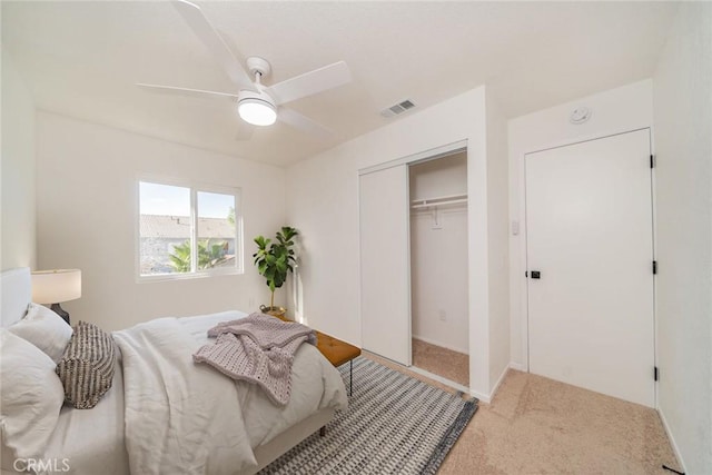 bedroom featuring ceiling fan, a closet, and carpet floors