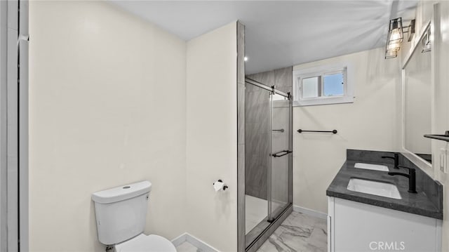 bathroom featuring an enclosed shower, vanity, and toilet