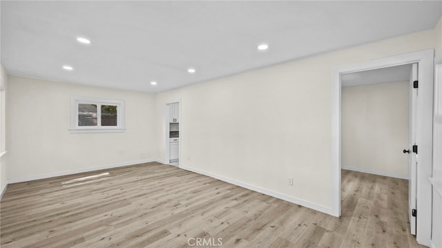 unfurnished room with light hardwood / wood-style flooring