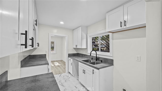 kitchen featuring white cabinets and sink