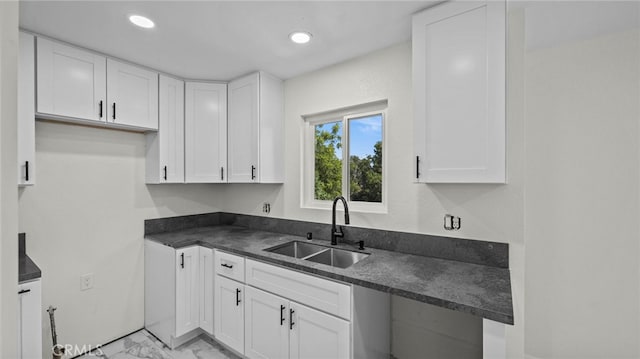 kitchen with white cabinetry and sink