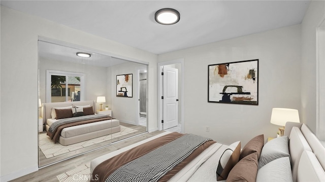 bedroom featuring light hardwood / wood-style flooring and a closet