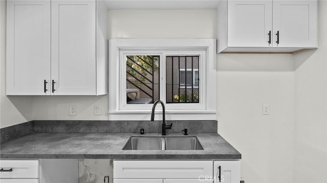 kitchen featuring sink and white cabinetry