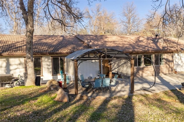 ranch-style house with a front yard, a patio area, and a gazebo