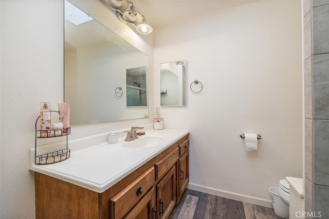 bathroom featuring hardwood / wood-style floors, toilet, and vanity