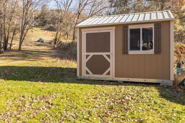 view of outbuilding with a yard