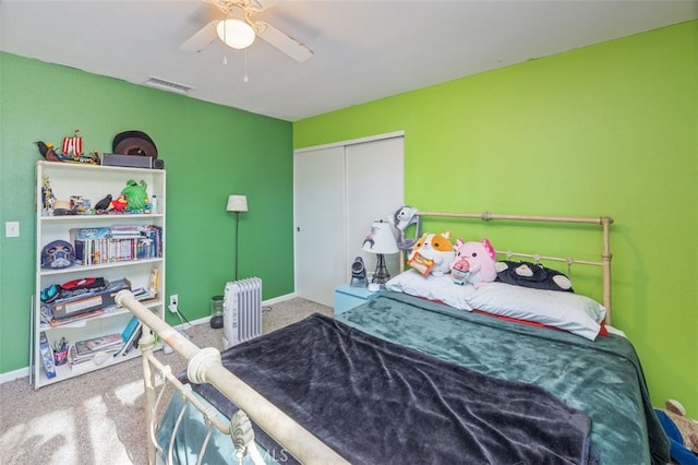 bedroom featuring ceiling fan, radiator, a closet, and carpet