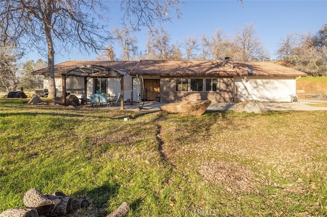 back of property with a patio area, a lawn, and a pergola