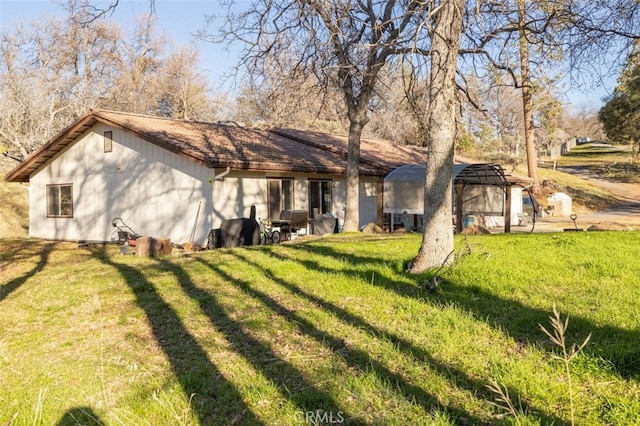 back of property featuring a lawn