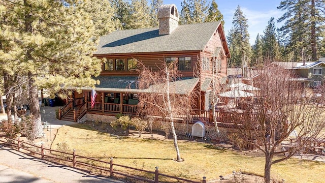 rear view of property featuring a yard