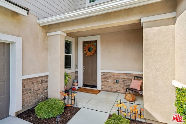 doorway to property featuring covered porch