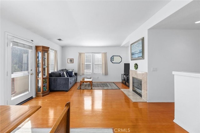 unfurnished living room with light wood-type flooring and a fireplace