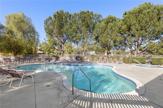 view of swimming pool with a patio area and a hot tub