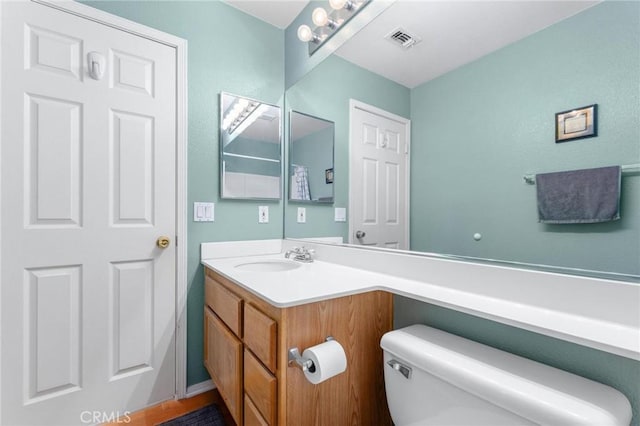 bathroom with toilet and vanity