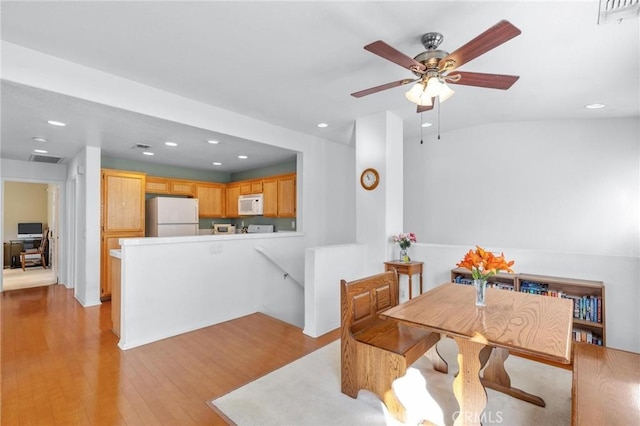 dining room featuring light hardwood / wood-style floors and ceiling fan