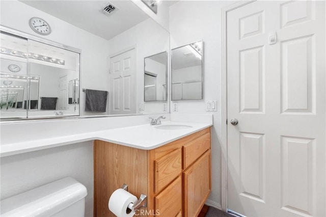 bathroom with toilet and vanity