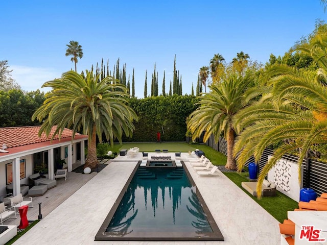 view of swimming pool with a patio area, outdoor lounge area, and a lawn