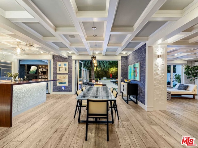 dining room featuring beamed ceiling, ornamental molding, coffered ceiling, and light hardwood / wood-style flooring