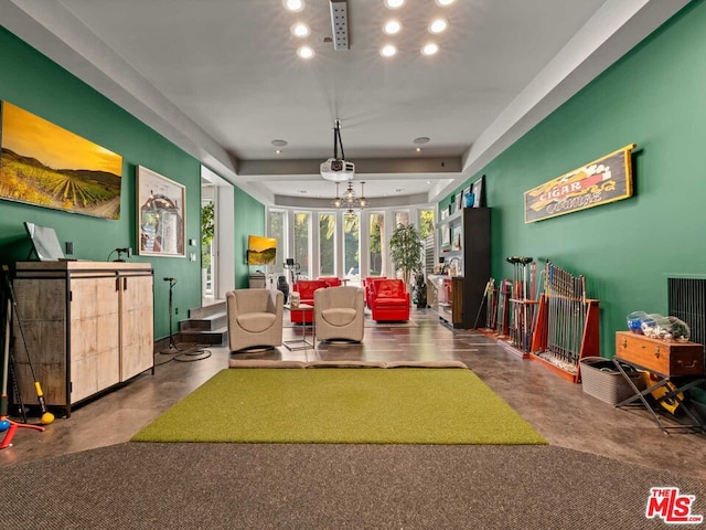 interior space featuring concrete floors and a raised ceiling