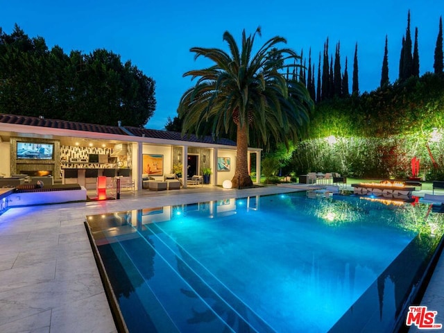 view of pool featuring a patio area, an outbuilding, and a jacuzzi