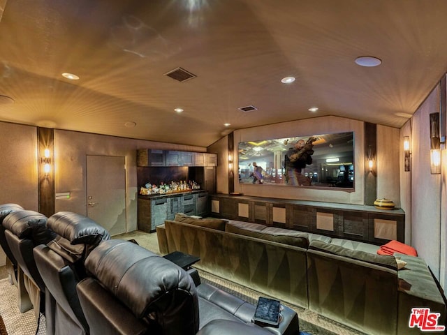 cinema room with bar area, carpet, lofted ceiling, and wooden walls