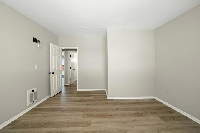 spare room with hardwood / wood-style floors