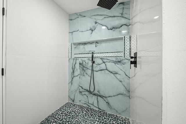 bathroom with a tile shower