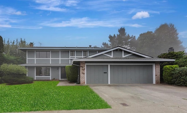 view of front property with a garage and a front yard