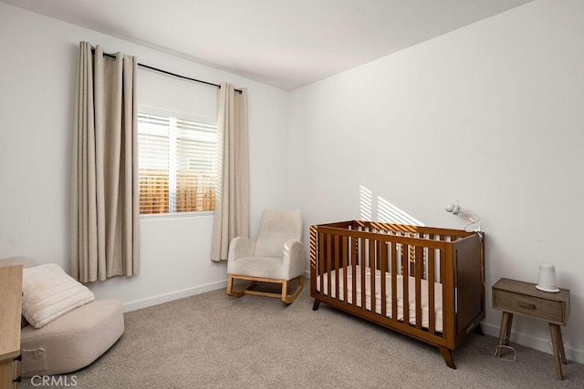 bedroom featuring light carpet and a crib