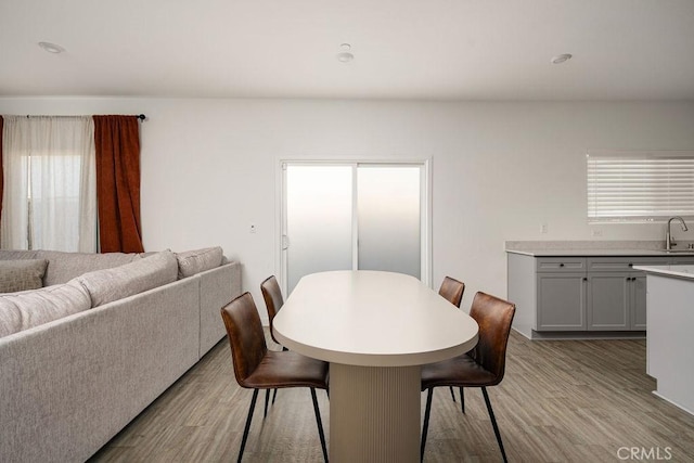 dining room featuring light wood-type flooring and sink