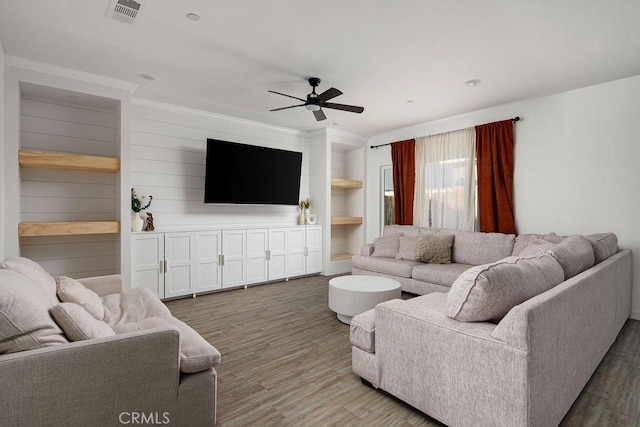 living room featuring ceiling fan, hardwood / wood-style flooring, and built in features