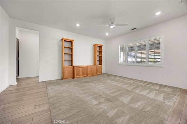 unfurnished living room featuring ceiling fan