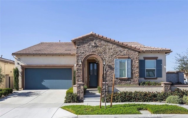 mediterranean / spanish-style house with a garage