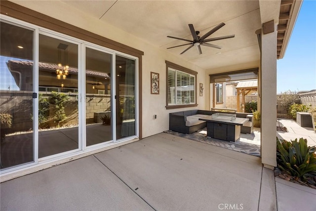 view of patio / terrace featuring ceiling fan and an outdoor living space with a fire pit