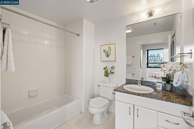 full bathroom with toilet, vanity, tiled shower / bath combo, and tile patterned flooring