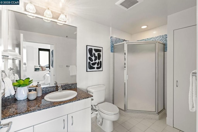 bathroom featuring a shower with door, tile patterned floors, toilet, and vanity