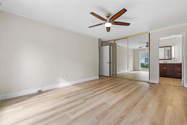 unfurnished bedroom with ceiling fan, connected bathroom, light wood-type flooring, a closet, and ornamental molding