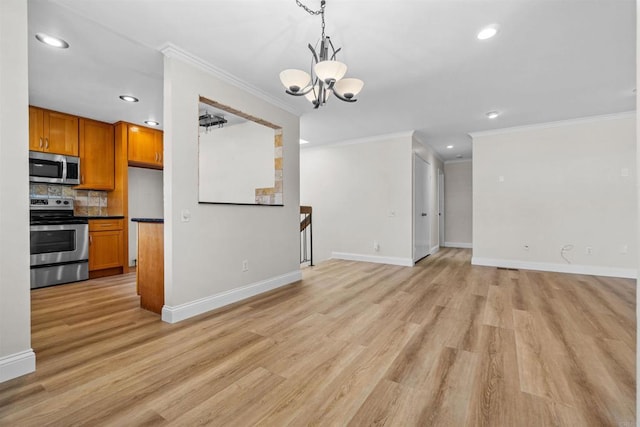 kitchen featuring tasteful backsplash, hanging light fixtures, stainless steel appliances, and light hardwood / wood-style floors