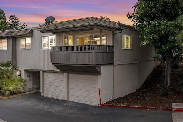 6309 Caminito Salado, San Diego, CA 92111 - view of front of property with asphalt driveway, a balcony, stucco siding, and a garage